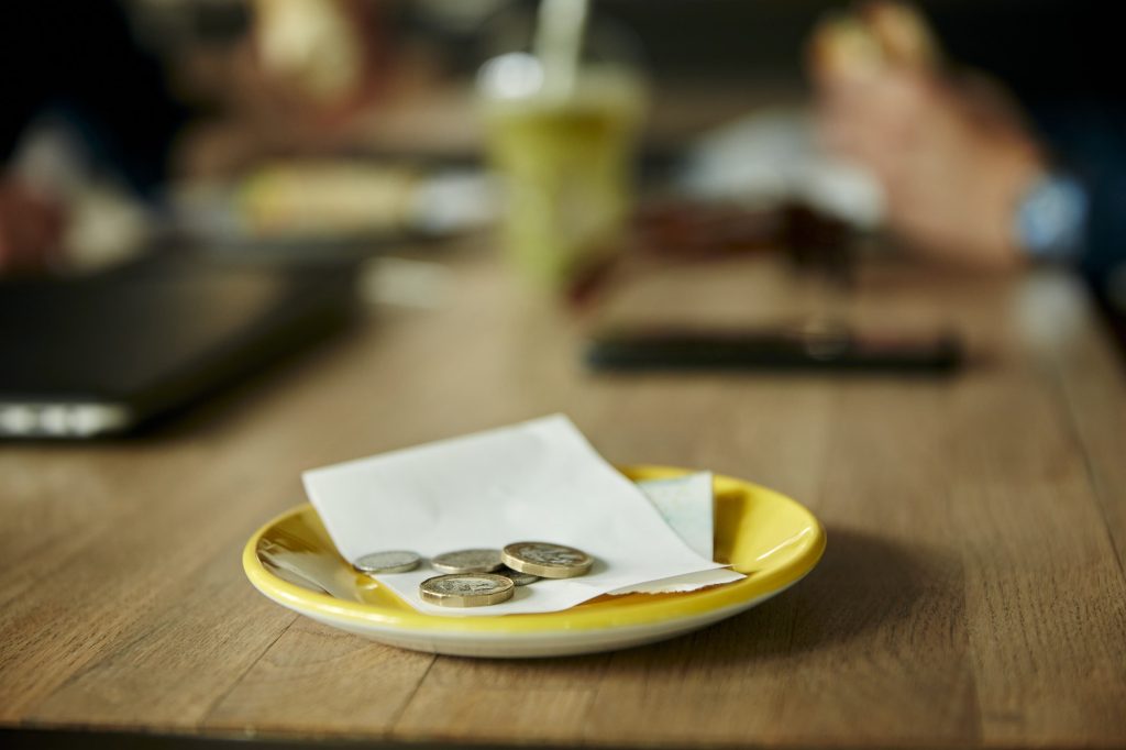 Coins and bill on restaurant table