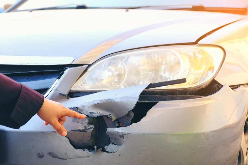Hand point to Front side of accident car. Car crash accident damaged automobiles