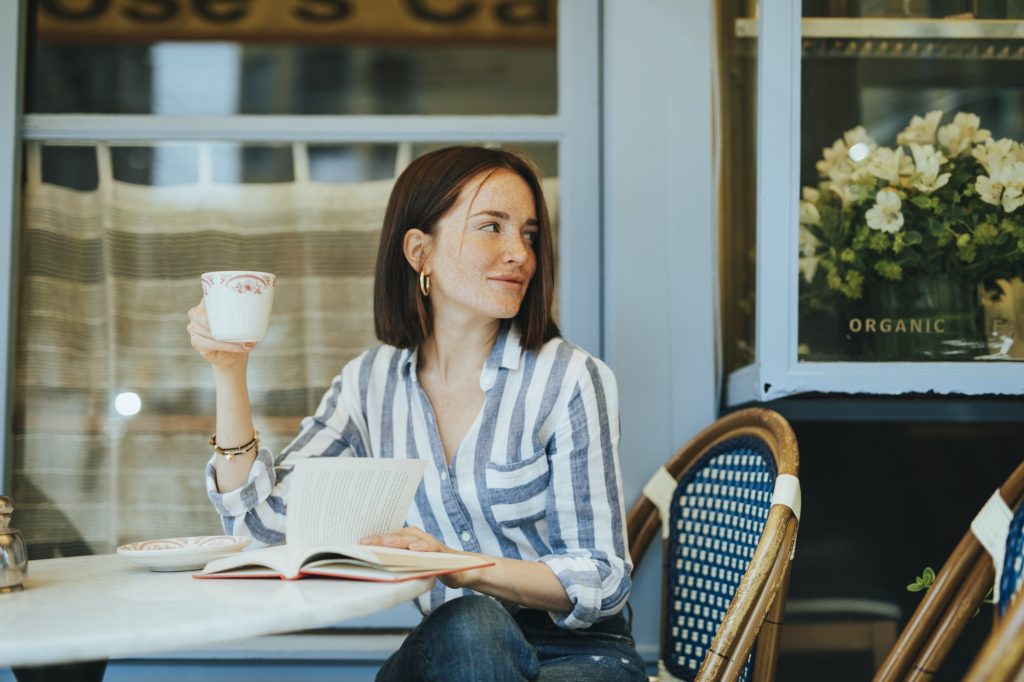 Woman reading a book at a cafe