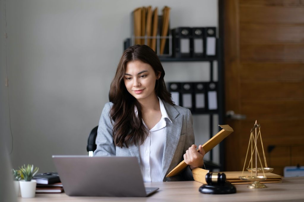 Asian lawyer woman working with a laptop computer in a law office. Legal and legal service concept.