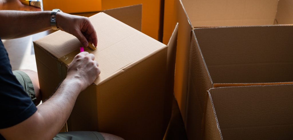 hand sealing parcel boxes at the warehouse distribution,