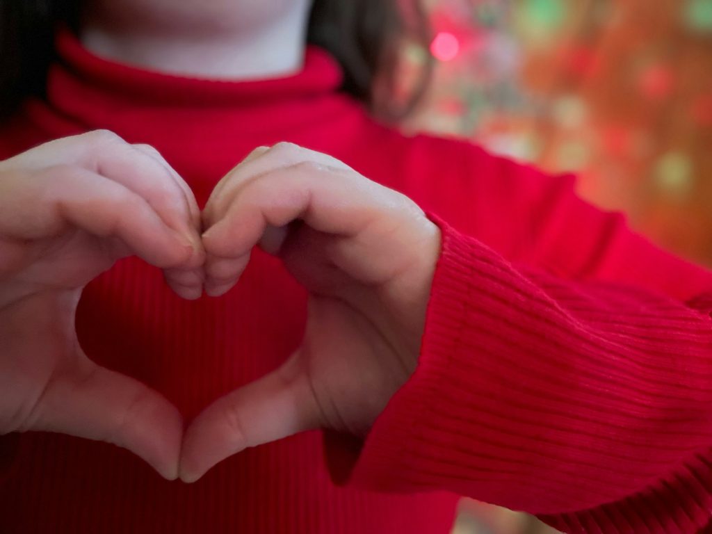 Loving charitable hearts at Christmas background