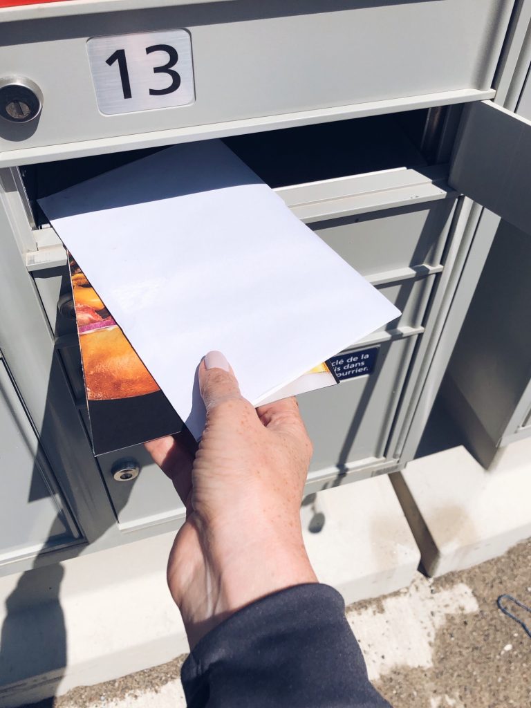 Woman is getting mail from community mailbox