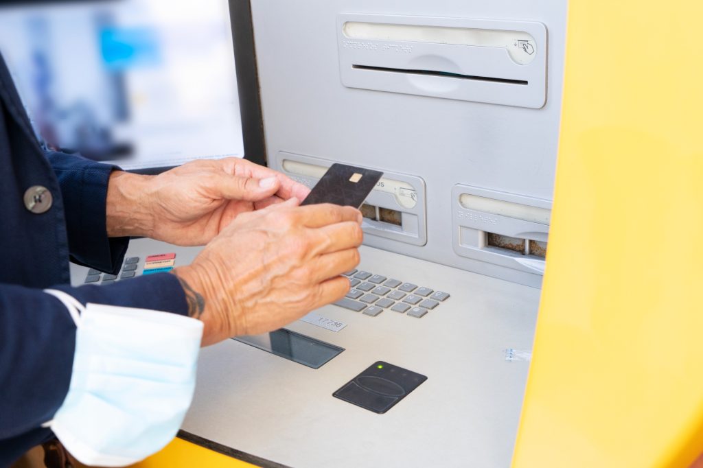 Senior man with ATM