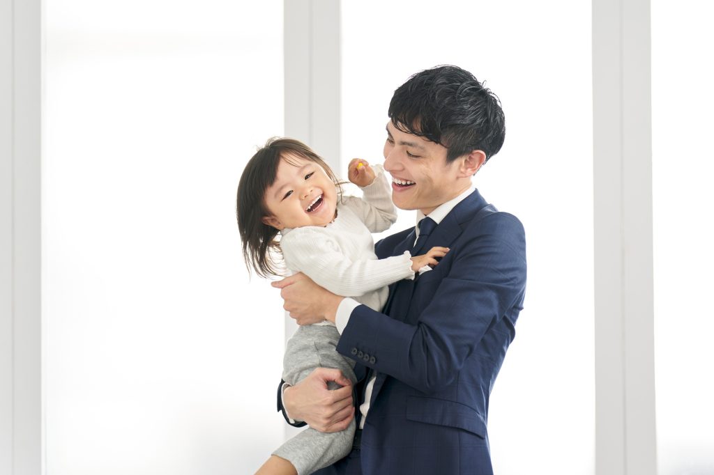 Businessman before work holding a child