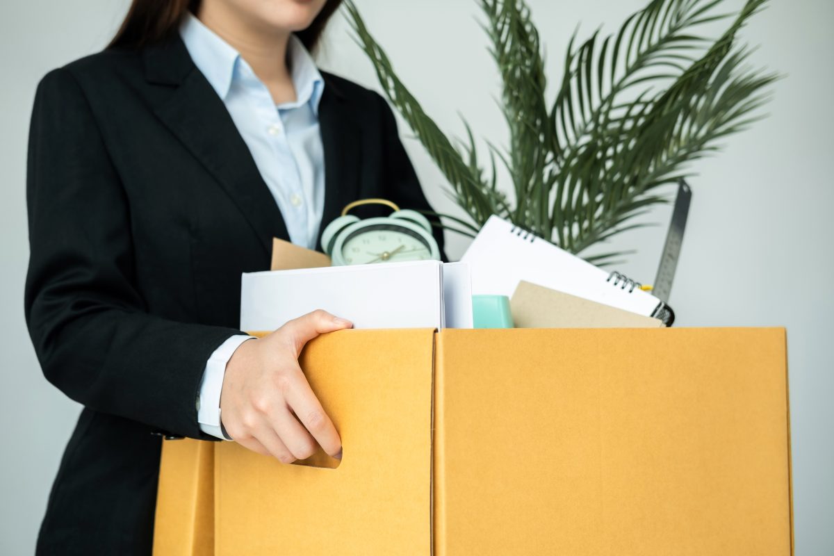 Business woman employee stressful resignation from job while picking up personal belongings