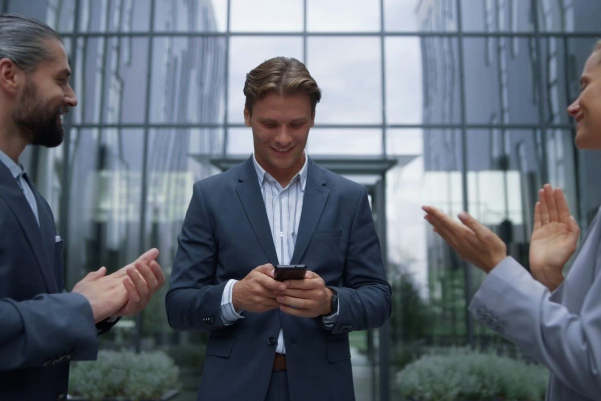 Businessman announce happy news to employees. Smiling staff applauding leader.