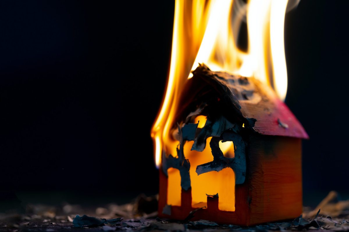 Closeup shot of a paper house burning