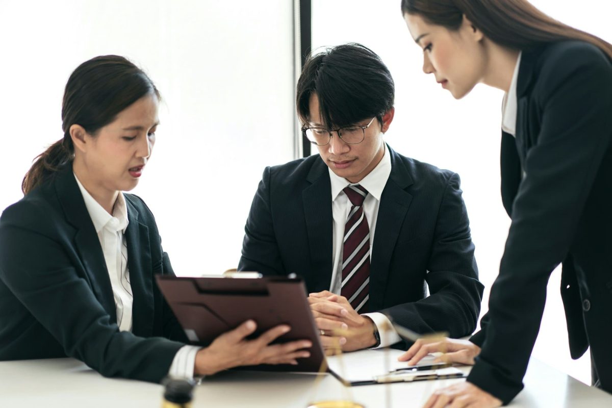 Female lawyer giving advice law and agreement of contract to client while business team reading