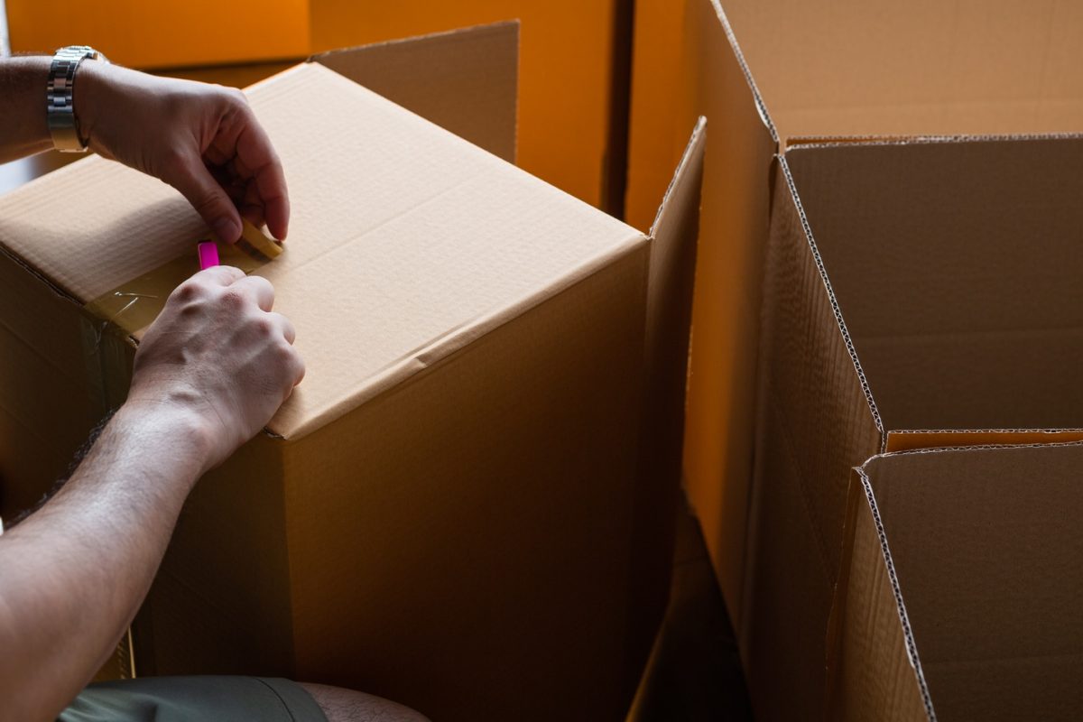 hand sealing parcel boxes at the warehouse distribution,