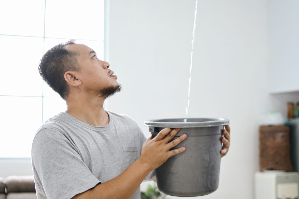 Man Collect Water From Leaked Roof