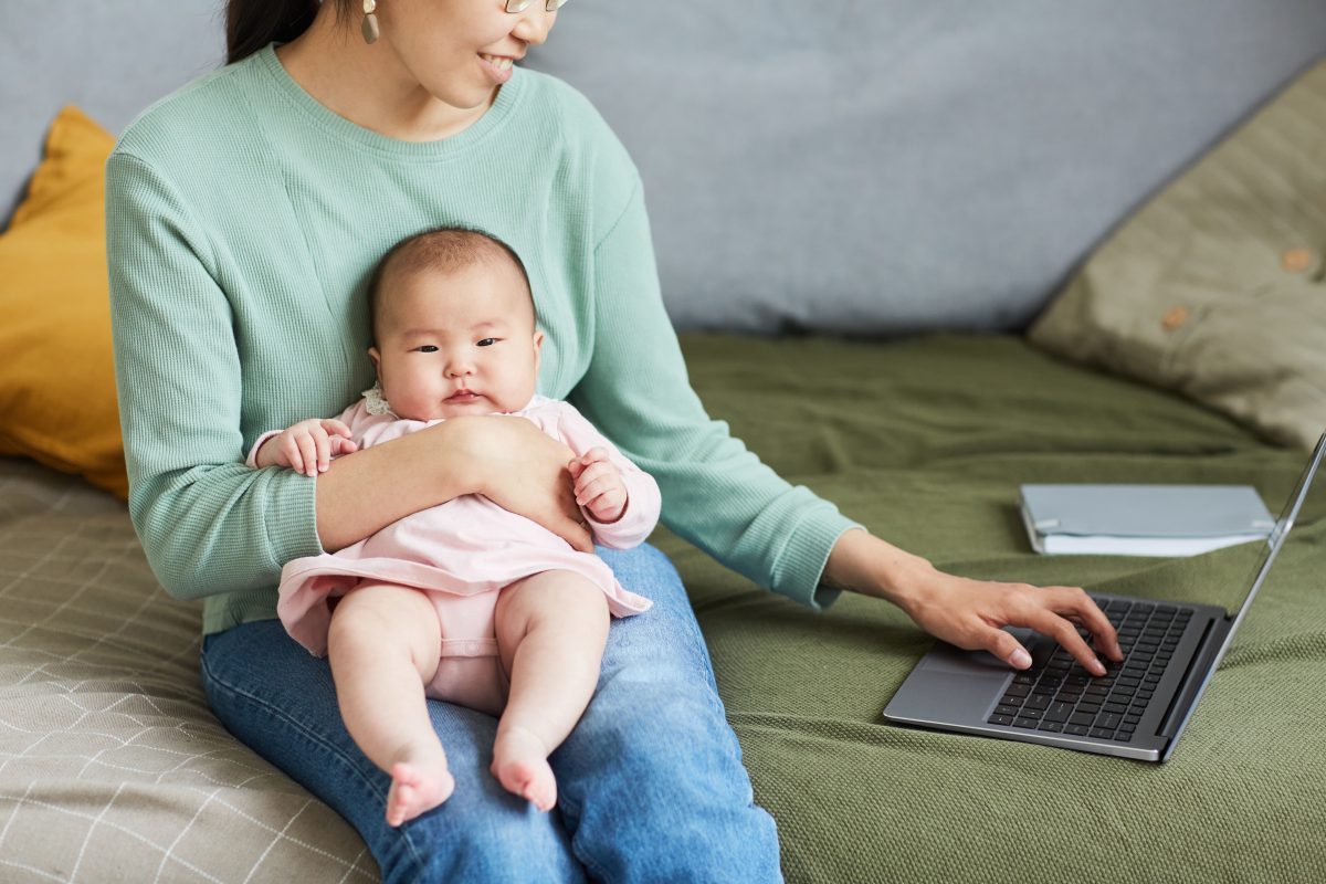 Woman working with baby at home